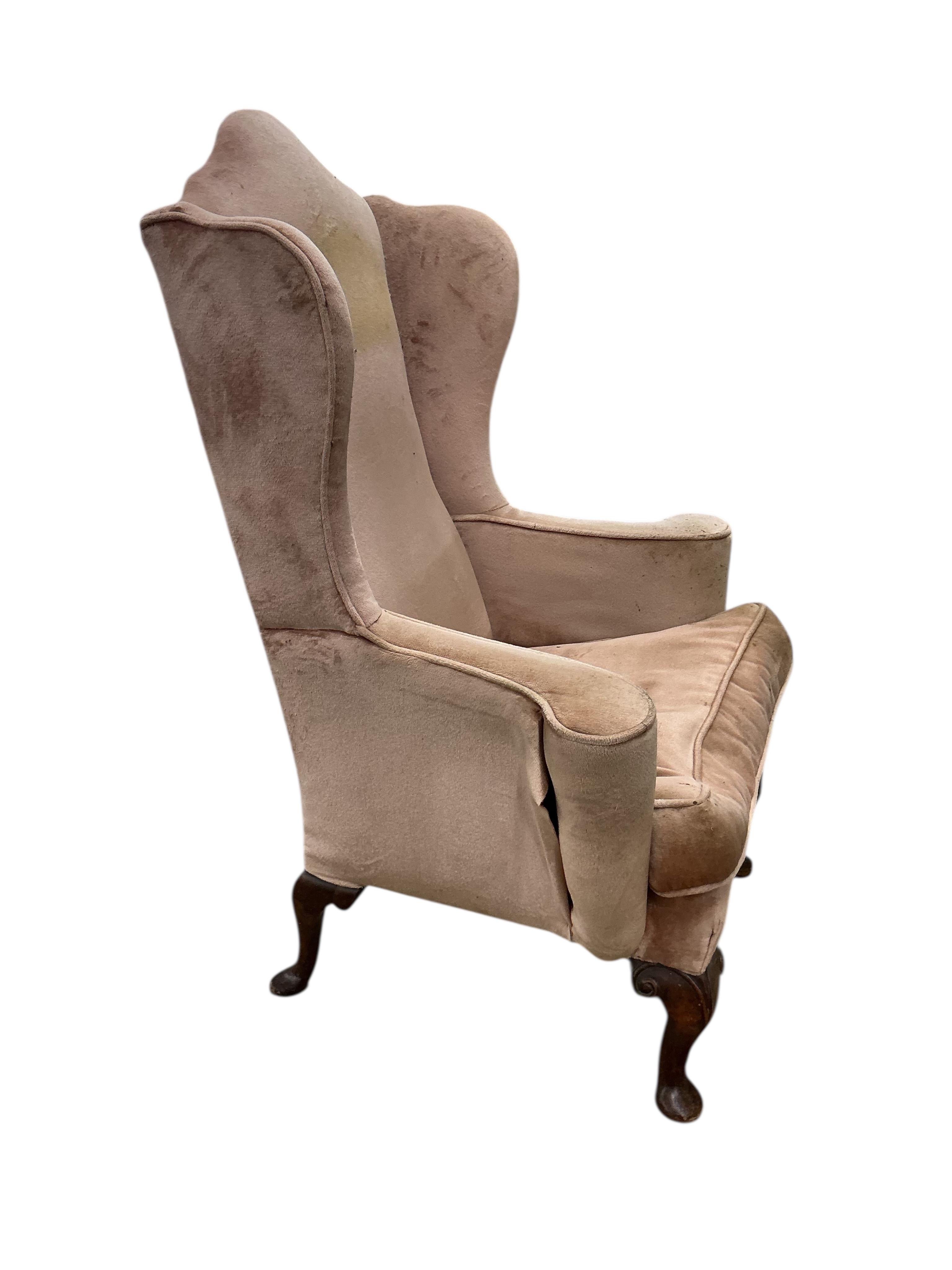 A Queen Anne Revival upholstered wing armchair, width 79cm, depth 60cm, height 116cm